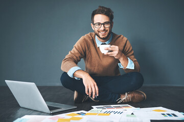Aufkleber - Work hard, break hard. Studio shot of a young businessman working with a laptop and paperwork against a grey background.