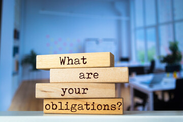 Wooden blocks with words 'What are your obligations?'.