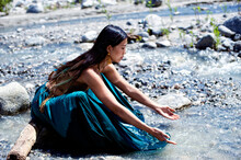 Photograph Of A Beautiful Woman In A Flowing River. 