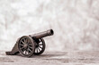 Ancient cannon on steel wheels with wall background retro style and copy space.
