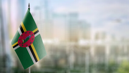 Wall Mural - Small flags of the Dominica on an abstract blurry background