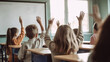 © Yeti Studio - Children raise their hands during a lesson in elementary school. Based on Generative AI