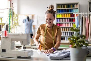 Young fashion designer working at her workplace
