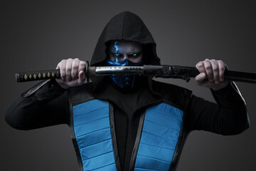 Studio shot of isolated on gray background ice assassin with katana sheathe katana.