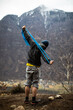 © lightpoet - A rock climber climbing on a boulder rock outdoors. Group of friends involved in sports outside.