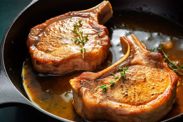 Wall Mural - Simple and delicious pan fried pork chops in sizzling butter with thyme. Traditional American cuisine dish specialty for family dinner holiday celebrations