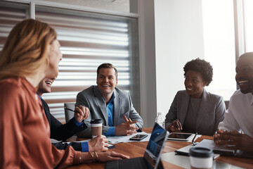 Sharing some great ideas around the table. a group of businesspeople having a meeting in an office.