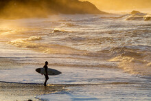 Surfer On The Beach At Sunrise, Sunset, Lone
