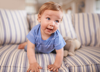 Poster - The cutest smile. an adorable little infant sitting on a sofa.