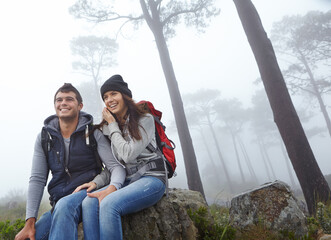 Sticker - Taking a break for some breathtaking views. a young couple taking a break while out hiking.