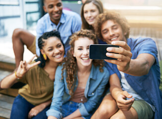 Wall Mural - Good times selfie. a group of students taking a selfie on campus.