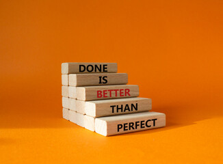 Wall Mural - Done is better than Perfect symbol. Wooden blocks with words Done is better than Perfect. Beautiful orange background. Business and Done is better than Perfect concept. Copy space.