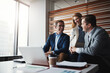 © GR/peopleimages.com - Working as a team of high-ranking executives. a group of businesspeople having a discussion in an office.