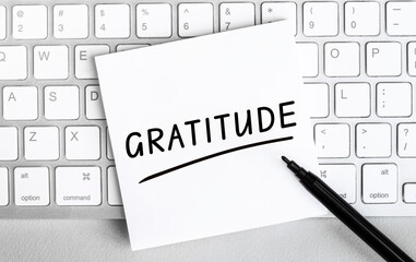 Wall Mural - White paper with text Gratitude lying on the keyboard