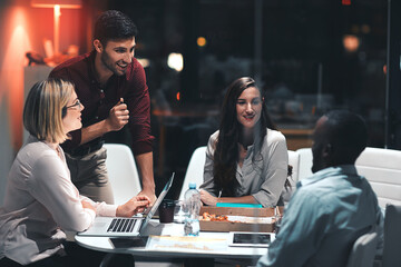 Getting the team together for a late night brainstorming session. colleagues having a meeting during a late night in a modern office.