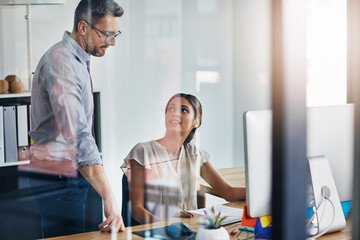 Aufkleber - Bettering an already good idea. two businesspeople working on a computer in an office.