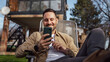© Miljan Živković - Man Talk on Smartphone in front of house Happy Smile have a phone call