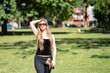 © Mariano - Portrait of blonde woman posing in a park. Model striking a pose in a park