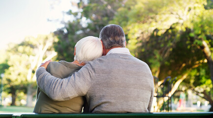 Wall Mural - This is what forever means. Rearview shot of an affectionate senior man embracing his wife while relaxing at the park.