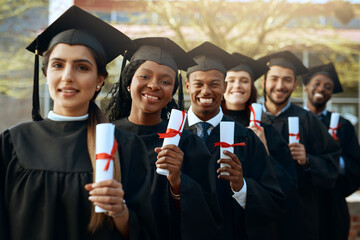 Poster - And now the working working world awaits. Portrait of a group of young students holding their diplomas on graduation day.