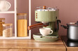 © Pixel-Shot - Modern coffee machine with cup on wooden kitchen counter