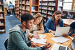 © Nola V/peopleimages.com - Theres only one way to succeed Work hard. a group of university student studying hard in a library.