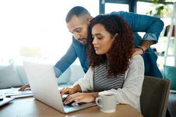 Wall Mural - Its more convenient to settle our bills electronically. a young couple planning their budget together on a laptop at home.