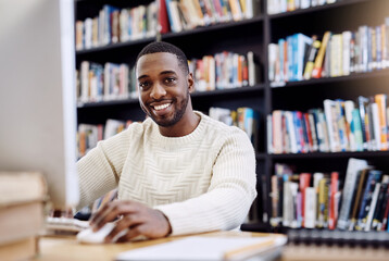 The internet has some great research information too. Portrait of a young man using a computer in a college library.