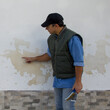 Image of a construction engineer illustrating damage to a brick wall due to moisture issues. Repair due to rising damp
