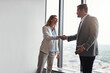 © GR/peopleimages.com - I cant wait to get started. Low angle shot of two corporate businesspeople shaking hands during a meeting in the boardroom.