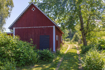 Poster - Dirt road by a barn in the countryside