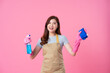 portrait of asian girl wearing apron on pink background