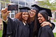 © Marius V/peopleimages.com - Education, women celebrating graduation with selfie and group at the ceremony outside on campus. University or college academic achievement, female students take photo and people dressed in cloaks