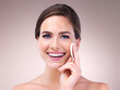 © Tamani Chithambo/peopleimages.com - Happiness is a habit, so is your skincare. Studio portrait of an attractive young woman using a cotton pad on her face against a pink background.