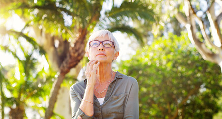 Wall Mural - Whats your advice to your younger self. a senior woman looking thoughtful at the park.