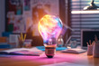 © alones - Creative colorful light bulb glows with pink and blue light in the office workplace. Think differently, creative idea