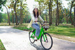 © snowing12 - Women riding bicycle with having fun to relaxation and exercise for healthy lifestyle in the park
