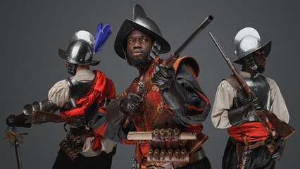 Canvas Print - Portrait of multiethnic group of three conquistadors with steel armors and flintlock rifles.