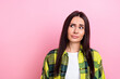 Portrait of cute girlish funny woman with long hairdo wear plaid shirt look at billboard empty space isolated on pink color background