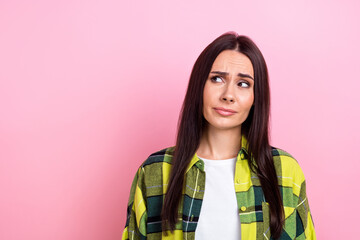 Wall Mural - Portrait of cute girlish funny woman with long hairdo wear plaid shirt look at billboard empty space isolated on pink color background