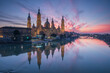 del Pilar basilica, one of the important architectural symbols of zaragoza, and the Ebro river and its reflection with sunset colors and clouds