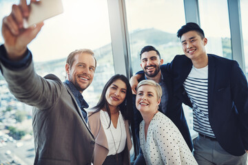 Poster - The world should know of the force that we hold. a group of businesspeople taking a selfie together in an office.