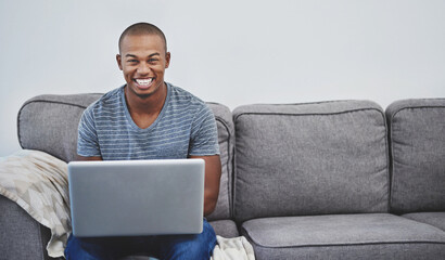 Poster - Finally a chance to browse at leisure. Portrait of a handsome young man using a laptop at home.