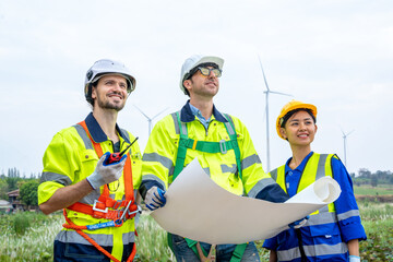 Wall Mural - Group of engineers planning discuss project ann working in wind turbine farm,Sustainable future.