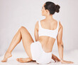© C.D./peopleimages.com - Beauty, back and body of woman in underwear in studio isolated on a gray background. Lingerie, skincare and fitness, body care and wellness of slim, young and beautiful female model sitting on floor.