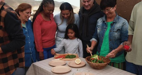 Wall Mural - Group of multiracial friends having fun preparing food for barbecue at house rooftop - Multi generational people enjoy day together outdoor during weekend day 