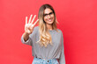Young Uruguayan woman isolated on red background happy and counting four with fingers
