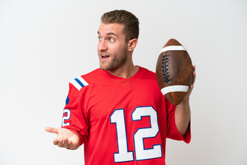 Wall Mural - Young caucasian man playing rugby isolated on white background with surprise expression while looking side