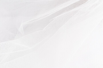 Part of the white bride's wedding veil as a background for the design. The concept of the wedding.
