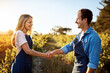 © Stratford/peopleimages.com - Partnering up to bring quality produce. a handsome young man and an attractive woman shaking hands on a farm.